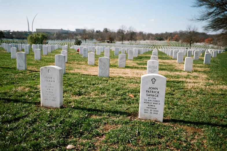 gravestones of military men on an open grassy field