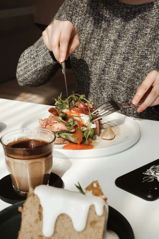 a woman is  up her plate of food at a cafe