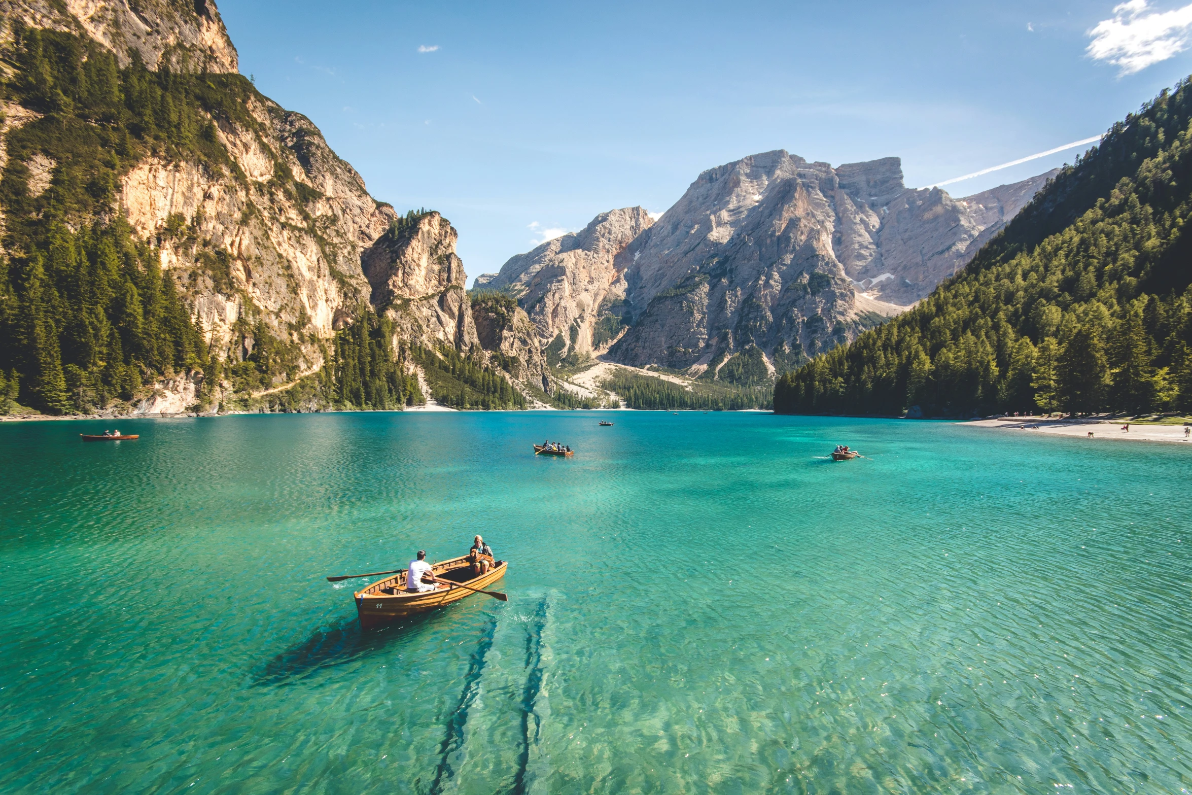 a couple of boats in a lake with mountains in the background