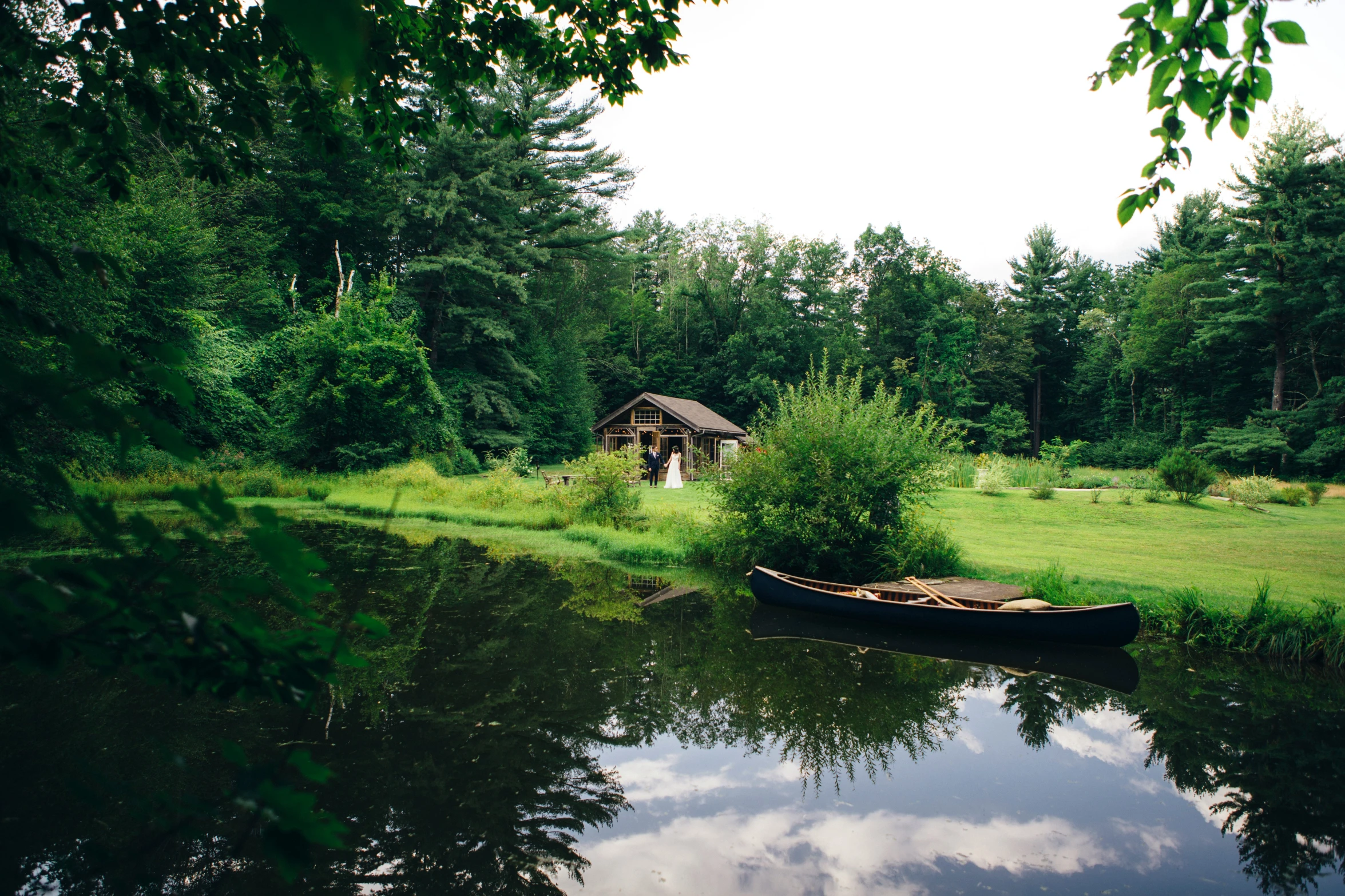 a small boat on a river in a forest