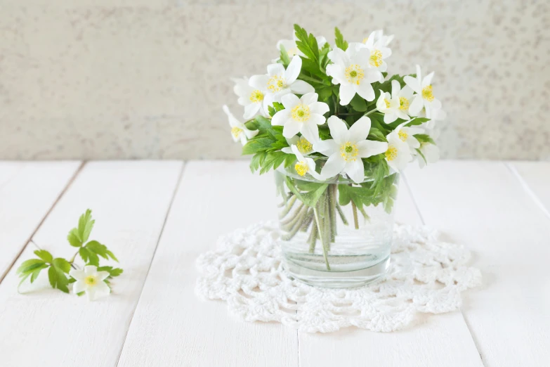 a vase full of white flowers sitting on top of a table