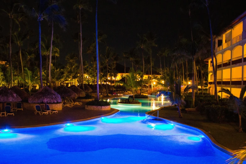 a large pool lit up with blue lighting