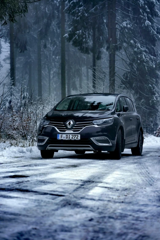 a car traveling down the road on snow covered ground