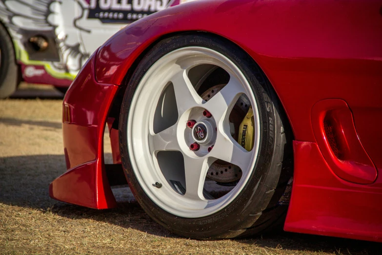 a close - up of the tire on a red sports car