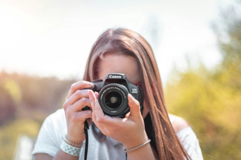 a woman is holding up her camera to take a picture