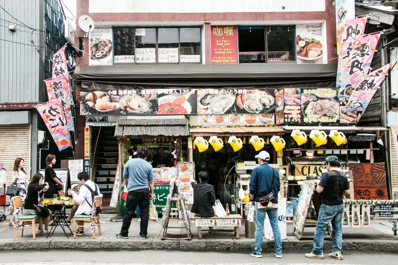 two men and two women standing in front of a store