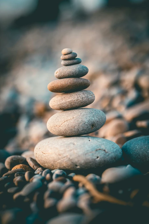 three pebbles are stacked up on some rocks