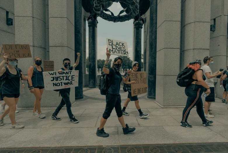 people with signs on the sidewalk holding up some type of bags