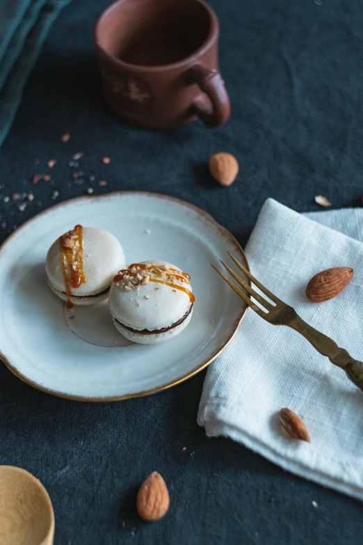 a plate topped with two desserts on top of a blue table