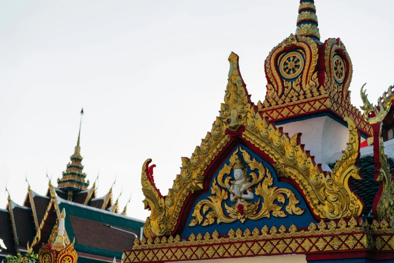 an intricate gold, blue, and red building with three levels