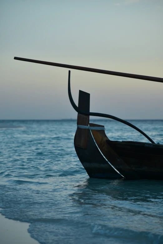 an old wooden boat is sitting on the water