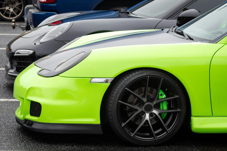 two green cars parked side by side in the parking lot