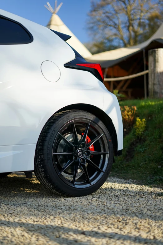 a close up of the tire on the front of a white car