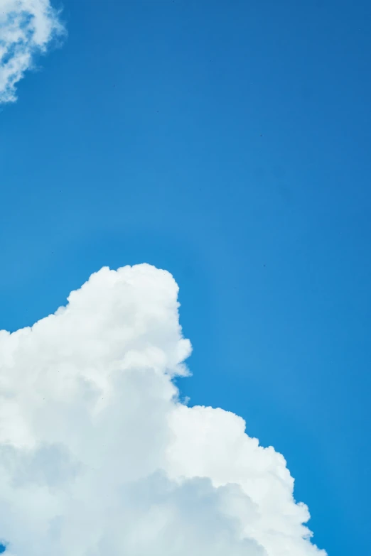 airplane in the sky with white clouds under it