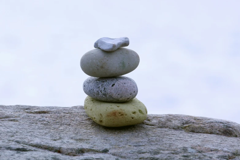 a rock pile with a rock with a sculpture on top