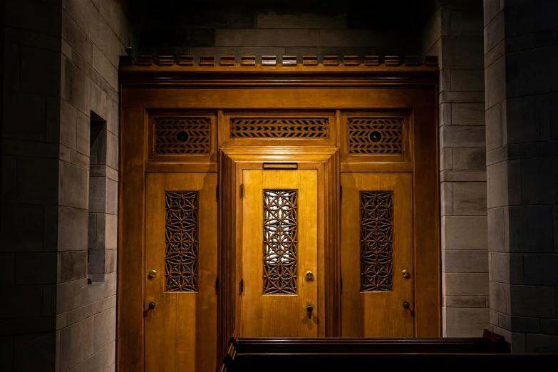 a wooden door in an arch over a bench