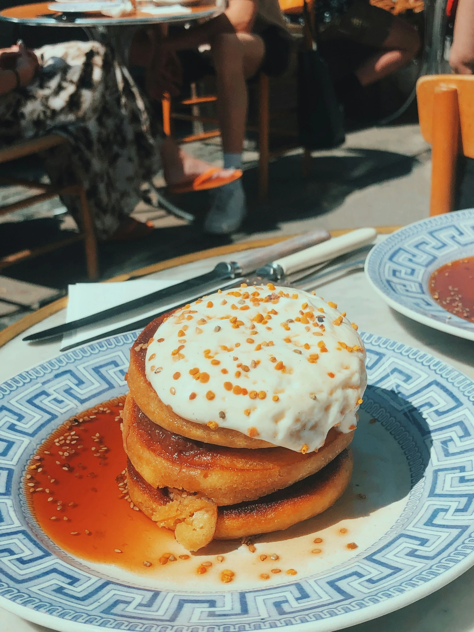 a plate topped with waffles and sauce covered in whipped cream