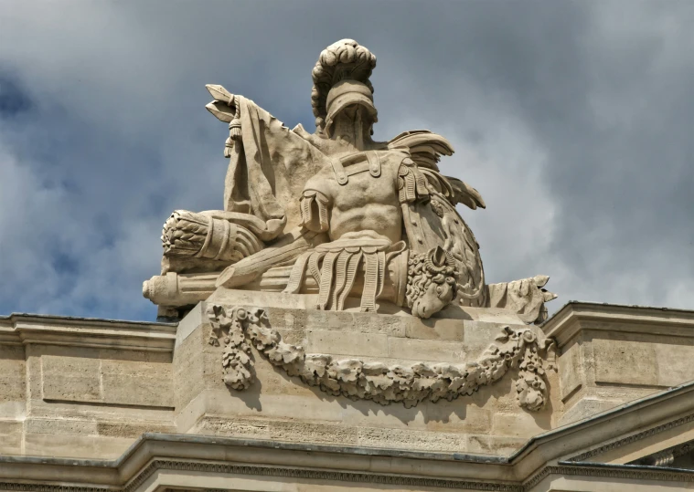 the front side of a building with an elaborate statue on top