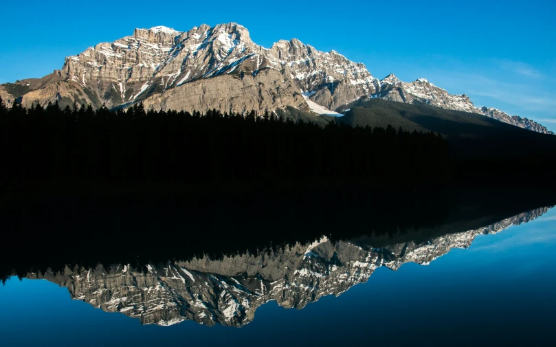 a body of water with mountains in the background