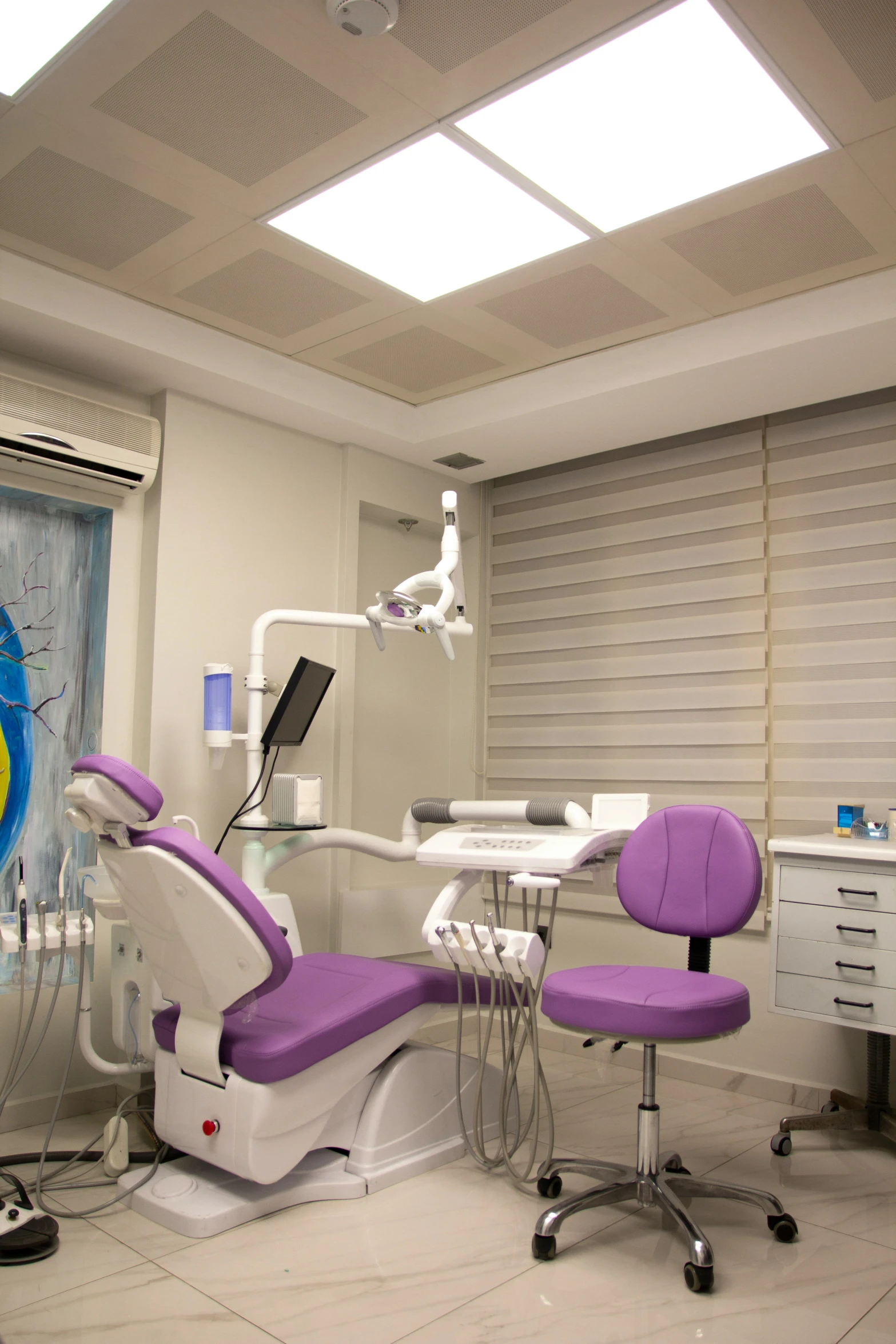 dental room with purple chairs on the floor and sunlight