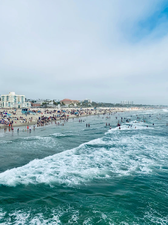 people enjoy the beach and surf waves