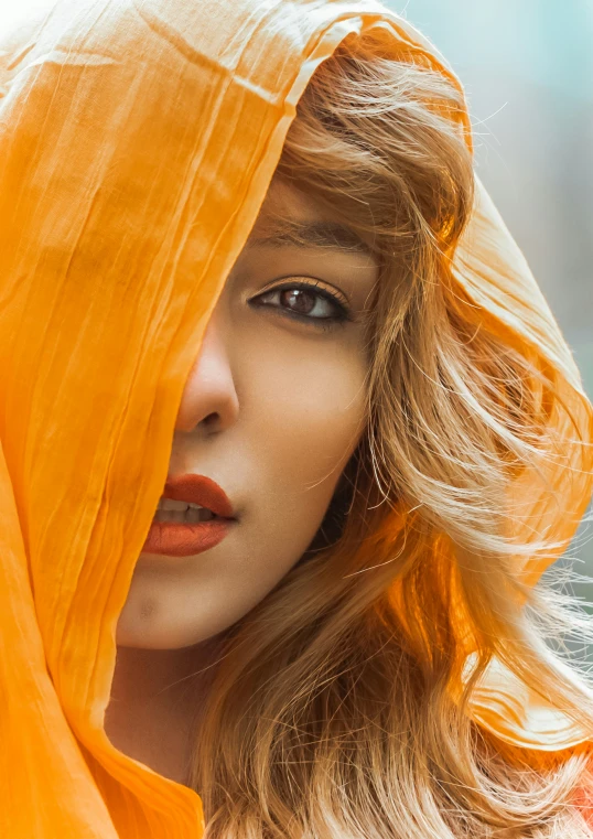 a woman with a yellow veil over her head