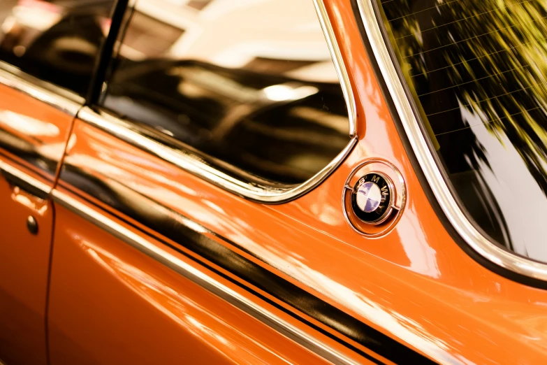 an orange car that is parked on the street