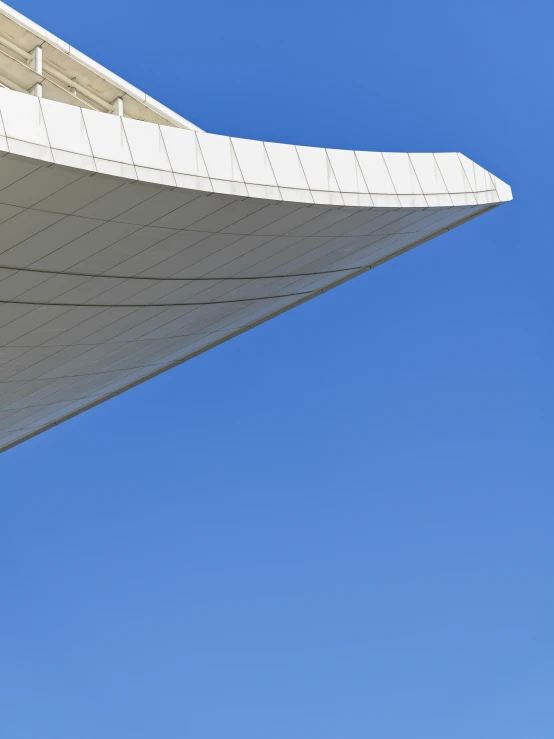 an airplane flies over the top of a building