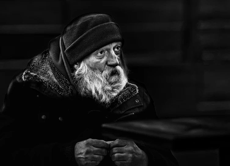 black and white pograph of an old man wearing a beanie