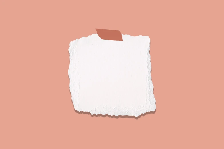 a torn piece of white paper against a peach background