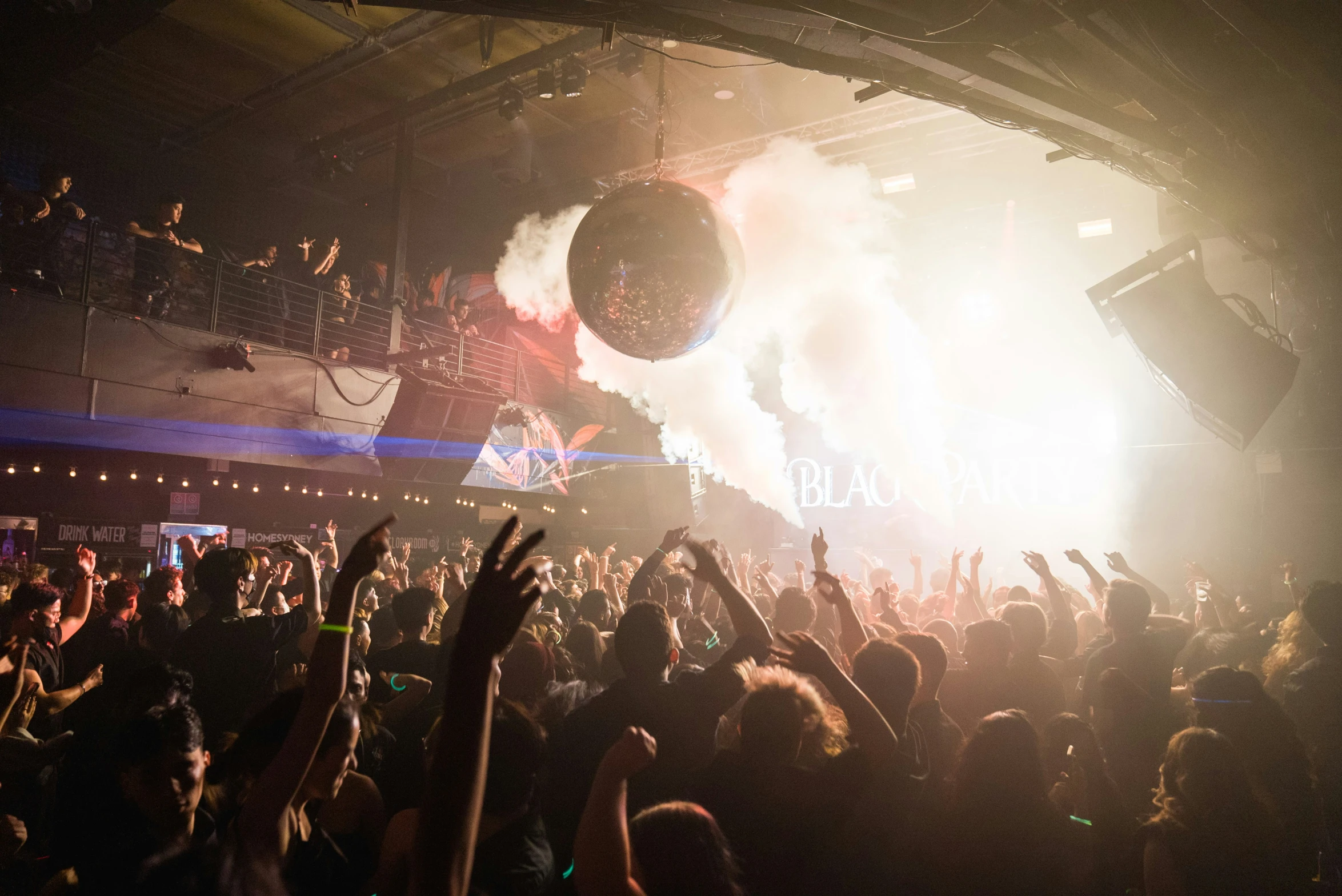 a crowd of people watching an electronic device move through the air