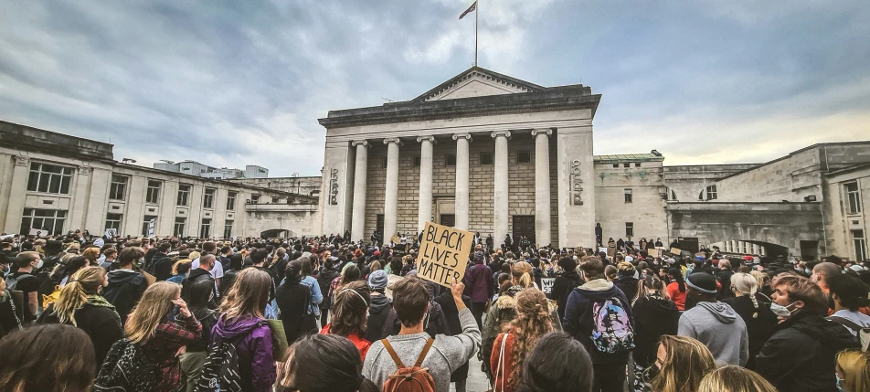 people standing around the steps at the building