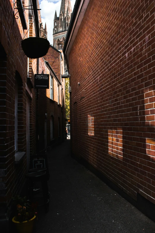 there is a narrow alley way going past buildings