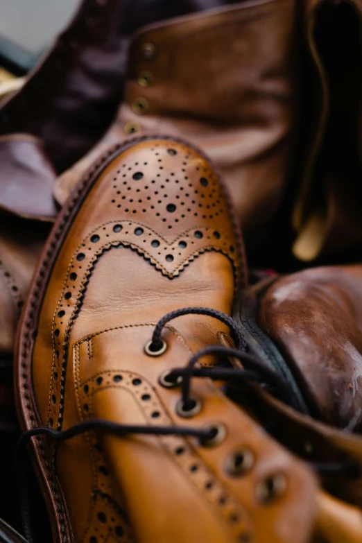 a pair of brown shoes with laces on them