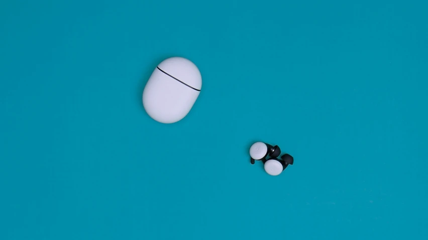 two pill shaped objects laying on a blue background