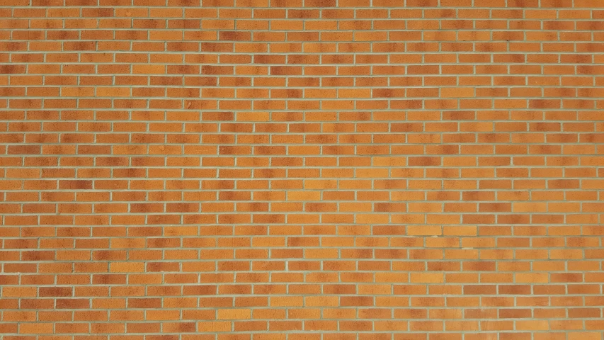 an orange and yellow brick wall that has a white top