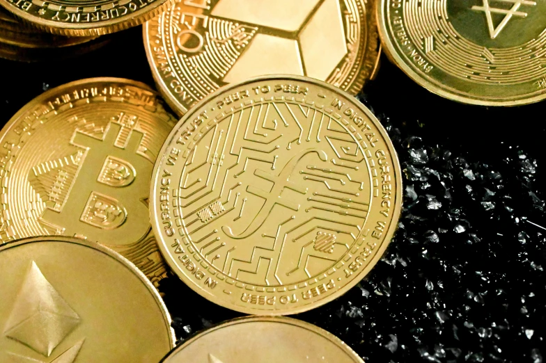 gold crypt coins with a blue diamond symbol on one coin