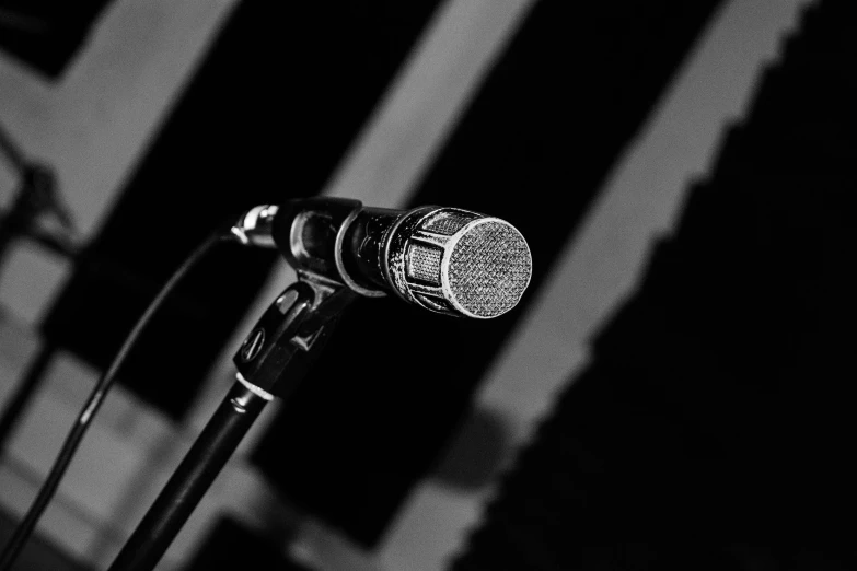 an old mic sitting in front of some windows