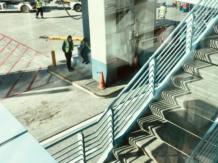 an airport has a control tower with people standing around