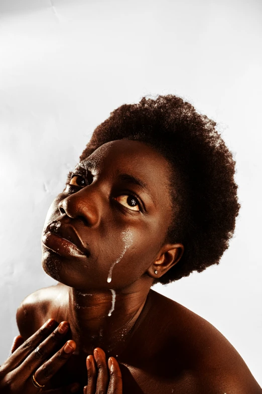 a woman is washing her face with soap