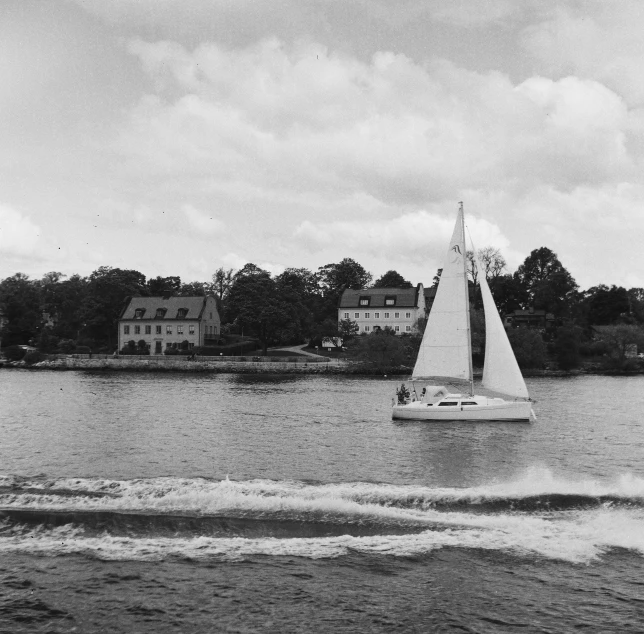 boat on the water with a city in the background