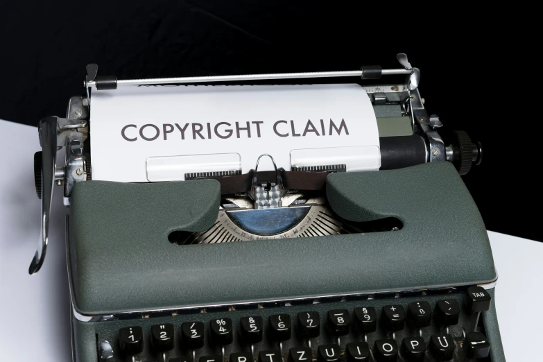 a close up of a typewriter that says copyright claim