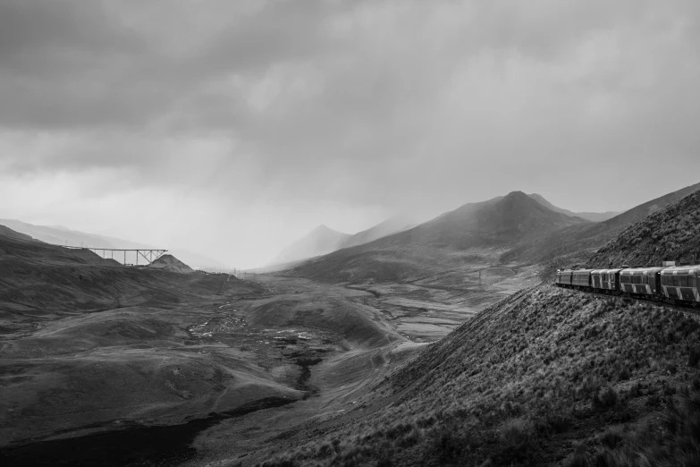 a train traveling down the tracks in a valley