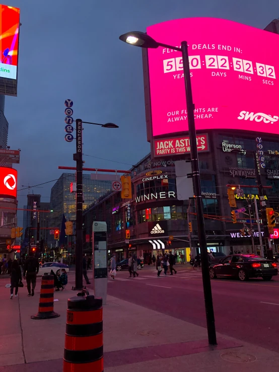 a cityscape that features billboards, buildings and street lights