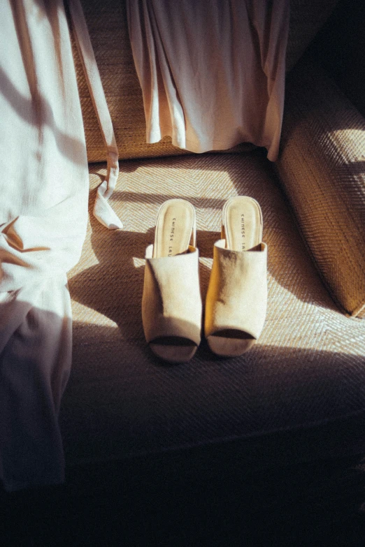 a pair of white slippers sitting on top of a chair