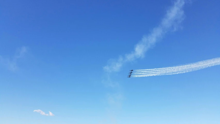 an air craft is in the sky with smoke trailing behind it