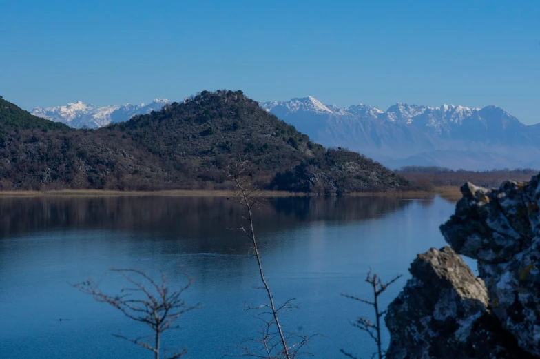 a large body of water with mountains in the background