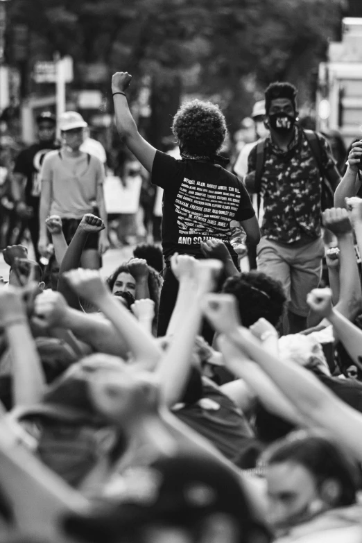 a man walking down a street with his arms in the air