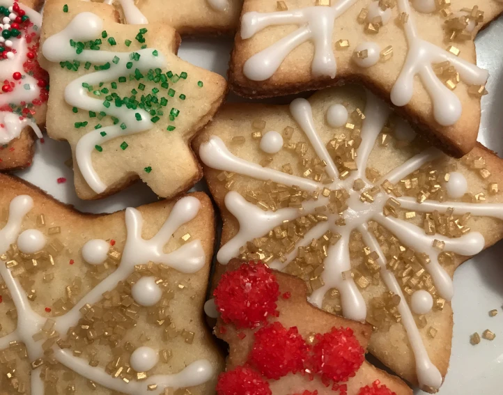some cookies are decorated like snowflakes and decorations