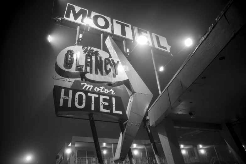 a large motel sign with lights above it